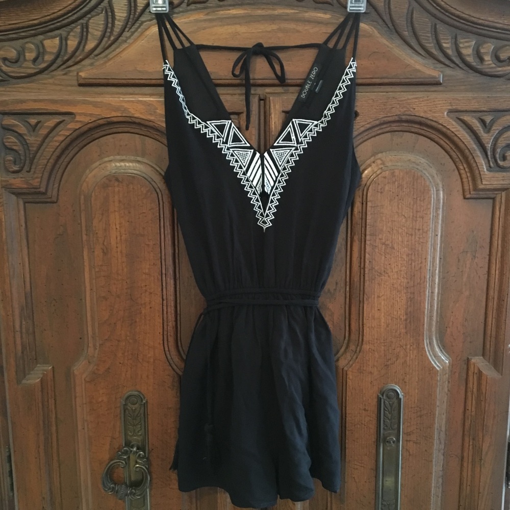 Black romper with white stitched embellishment